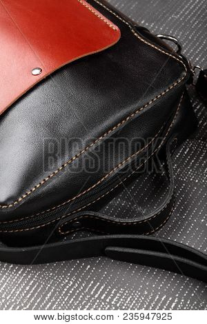 Messenger Bag .leather Black And Red Handmade Bag On Gray Background.closeup