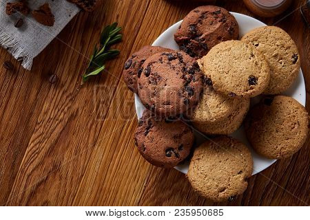 Side View Of A Plate Of Chocolate Chip Cookies On A White Plate Homespun Tablecloth Illuminated With