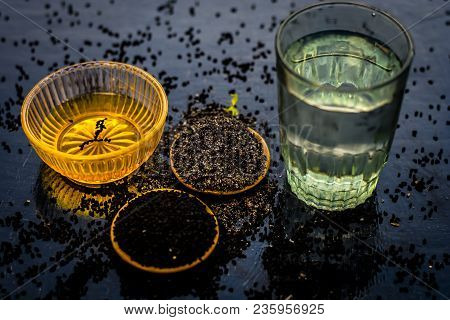 Close Up Of Kalonji Or Roman Coriander With Water And Honey On Wooden Surface Beneficial For Diabete