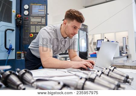 Male Engineer Using CAD Programming Software On Laptop