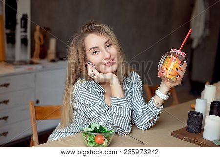 Caucasian Young Girl 20-25 Years Old Sitting At The Table Indoor With Bottle Glass Of Fresh Summer L