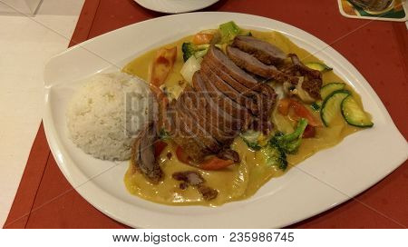 Delicious Asian Food With Duck, Rice, Sweet Sour Sauce And Paprika, Mushrooms, Zucchini