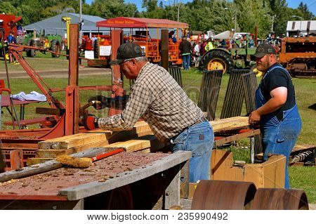 Dalton, Minnesota, Sept 8, 2017: Several Unidentified Sawyers Cut Dimensional Lumber At An Old Outdo