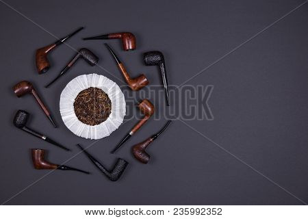 Different Smoking Tobacco Pipes And Tobacco In The Can On Dark Background With Copy Space. Top View.