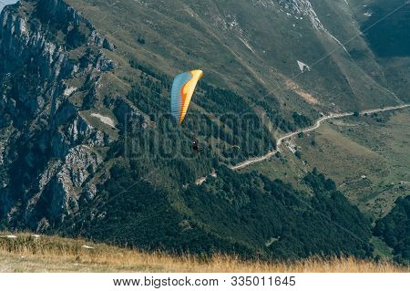 Monte Baldo, Italy - August 8, 2019: Paraglider In The Air On Top Of Monte Baldo By Lake Garda