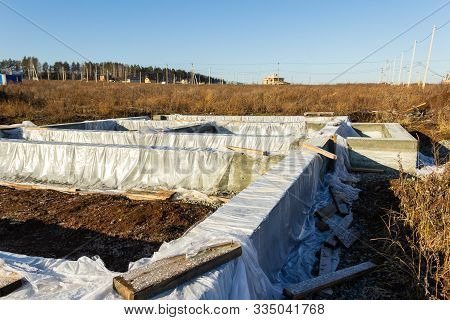 Foundation Construction For A House In A Cottage Village. Film Covered Foundation. Autumn, Sunny