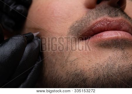 Male Trichopigmentation Service. Young Man Laying On The Back On The Esthetician Table. Master Hands