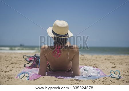 Balneario Camboriu, Santa Catarina, Brazil - November 18, 2019: Young Brazilian Woman Relaxing On Th