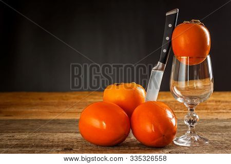Ripe Orange Persimmon Fruit.kaki Fruit On Wooden Table.slices Of Persimmon.set Of Kakis. Fruits Of K