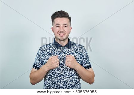 Pretty Young Caucasian Man Keeping Fists On Chest, Smile, Loooking Happy With Over Gray Background, 