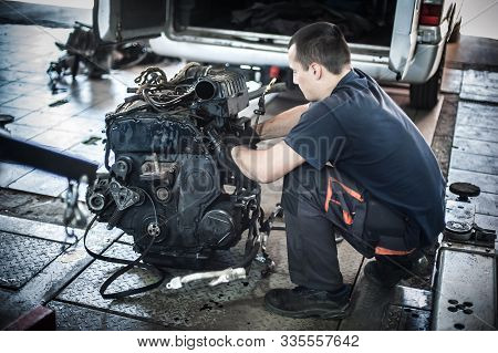 Removed Engine From Car. Auto Mechanic Repairs Car Engine