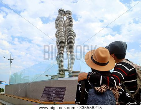 Couple Admiring The Famous Moving Lovers Monument Of Ali And Nino In Batumi City, Adjara Region, Geo