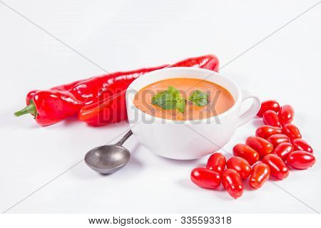 Gazpacho Soup With Some Tomatoes And Sweet Pepper , Decorated With Fresh Mint And Black Pepper On A 