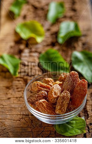 Dried Dates In Bowl. Dried Raw Organic Medjool Date Fruit And Green Mint In A  Bowl On Old Wooden Ta
