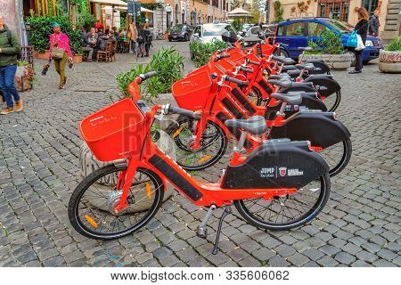 Rome, Italy - November 20 2019: Red Uber Jump Pedal-assist Bikes Parked. Dockless Electric Bicycle S