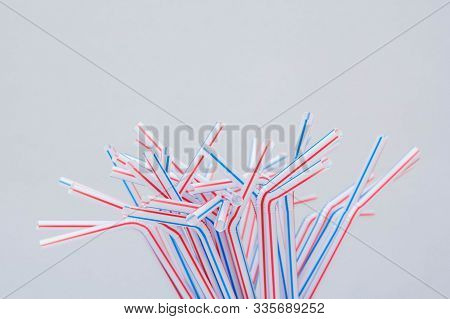 Drinking Plastic Straws On A Gray Background. Colorful Of Plastic Straws Used For Drinking Water Or 