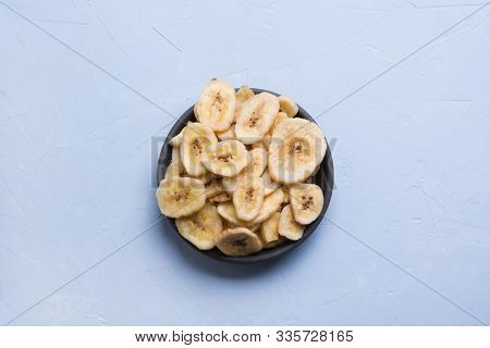 Dehydrated, Dried Banana Chips On Light Background. View From Above.