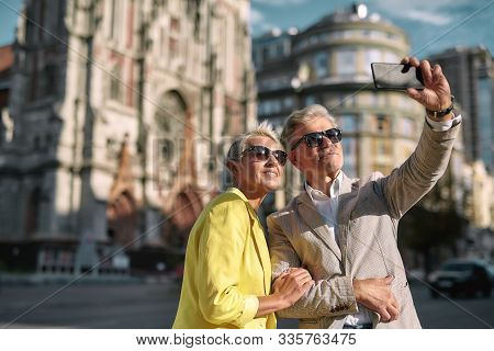Happy Moments. Beautiful Mature Caucasian Couple In Sunglasses Taking Selfie By Mobile Phone While S