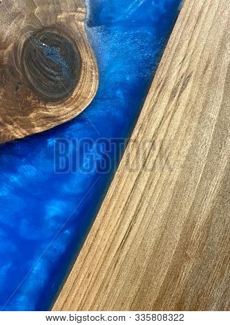 Beautiful wooden board with blue epoxy resin
