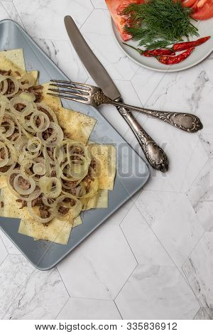Beshbarmak Is A National Tatar Dish - Square Pasta With Boiled Meat And Onions. On A Light Backgroun