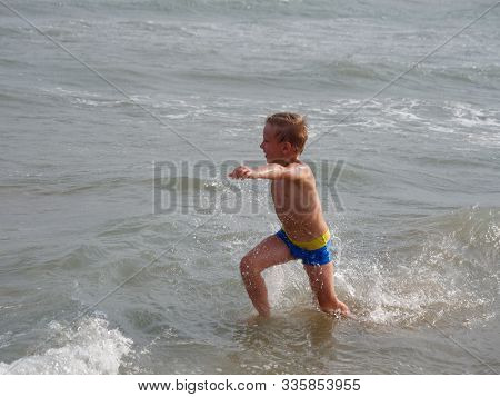 Children Swim In The Sea On The Beach In Bibione, Italy