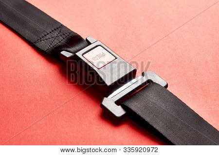 Fastened Seat Belt On Red Background With Copy Space, Close-up
