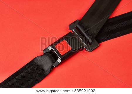 Fastened Seat Belt On Red Background With Copy Space, Close-up