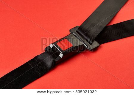 Fastened Seat Belt On Red Background With Copy Space, Close-up