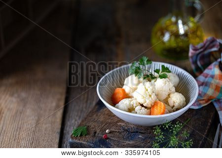 Pickled Cauliflower With Carrots In A Glass Jar On A Dark Wooden Table. Fermented Food. Copy Space.