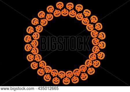 Bright Orange Pumpkins Are Arranged In A Circle In Two Rows, Forming A Frame On A Black Background. 