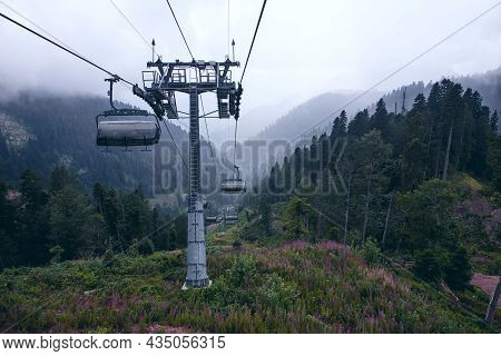Cable Car In The Mountains With Clouds Or Fog.view From The Cable Car To The Mountain Landscape.the
