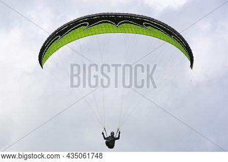 Paraglider Fkying Wing In A Blue Sky