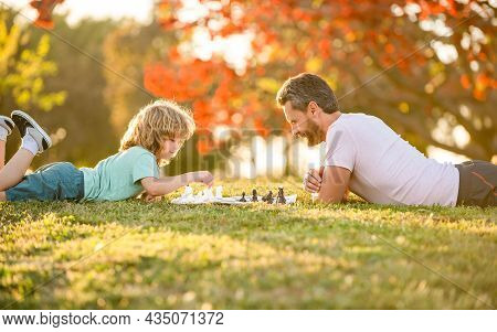 Spending Time Together. Strategic And Tactic. Tutorship. Dad And Kid Play Logic Game.