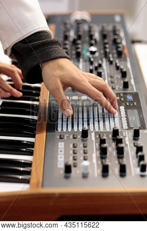 Musician Making Music With Polyphonic Analog Synthesizer. Selective Focus.