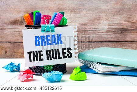 On The Desktop And Against The Background Of A Wooden Wall, There Is A Stand With Multi-colored Felt