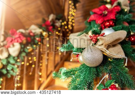 Close-up House Wooden Staricase Handrails Railings Decorated With Artificial Holly Poinsettia Flower