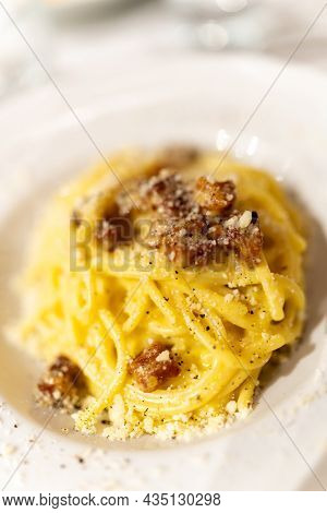 Spaghetti Alla Carbonara, Italian Pasta Dish From Rome Made With Eggs, Hard Cheese, Cured Pork, And 