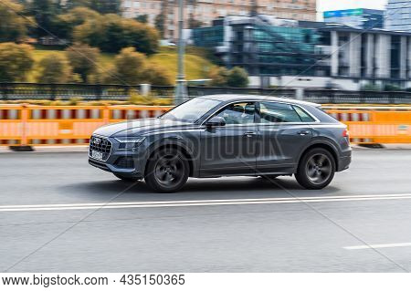 Audi Q8 Car Driving On City Streets With Motion Blur, View From The Side. Moscow, Russia - August 20