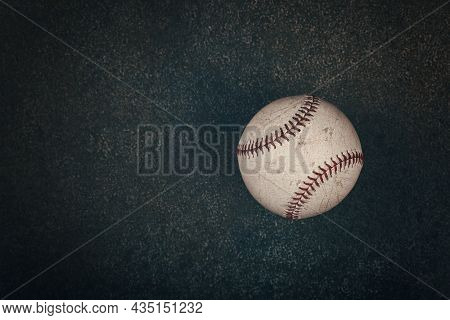 Close Up One Old Worn Vintage Baseball Ball With Red Stitch On Grunge Dark Brown Background With Cop