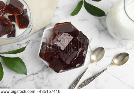 Delicious Grass Jelly Cubes, Milk And Green Leaves On White Marble Table, Flat Lay