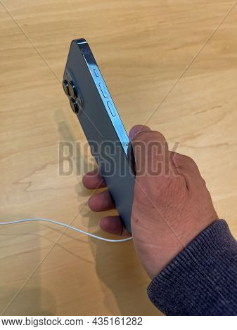 Cologne, Germany - October 01st 2021: A German Photographer Comparing And Testing The New Iphone 13 