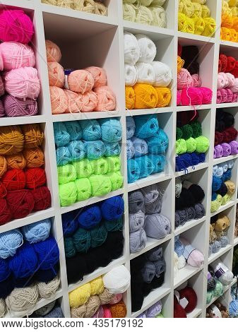 Colorful Yarns Of Wool For Knitting On Shelves In The Haberdashery Shop. Knitwork Handcraft Concept