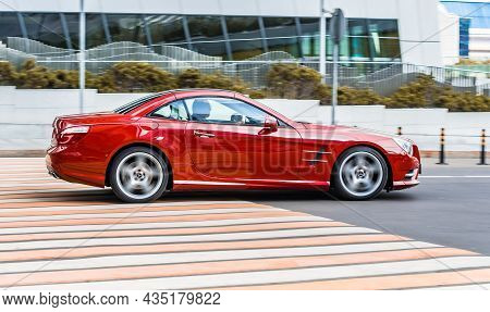 Red Mercedes Sl Class R231 Drive On Road In The City With Blurred Background. Mercedes-benz Sl 65 Am