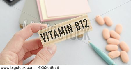 Hand Holds Wooden Cubes In His Hands With Text Vitamin B12