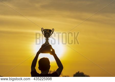 Winner Win Hands Holding Golden Champion Trophy Cup Prize. Silhouette Best Award Victory Hands Troph