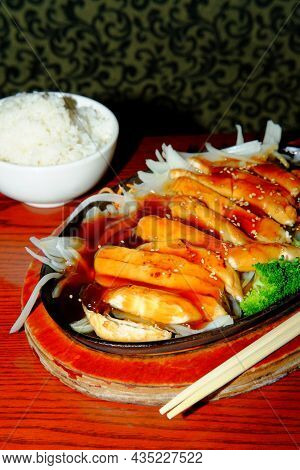 Japanese Teriyaki Chicken Dinner Served In Cast Iron Hot Plate