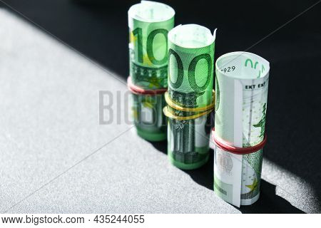 Close Up Of Euro Money Roll. Euro Banknote Set Cash Money - Eu Currency. Rolled With Rubber Euro Not