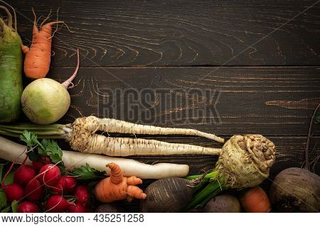Root Vegetables On A Wooden Background