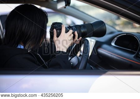 Woman Taking Pictures From Inside The Car