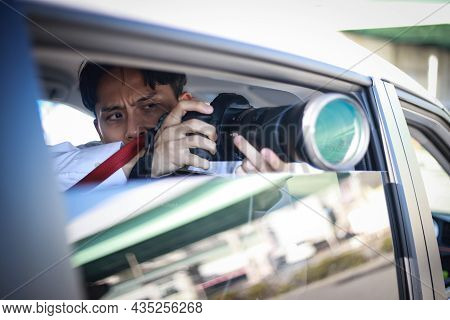 A Man Taking A Picture From Inside The Car